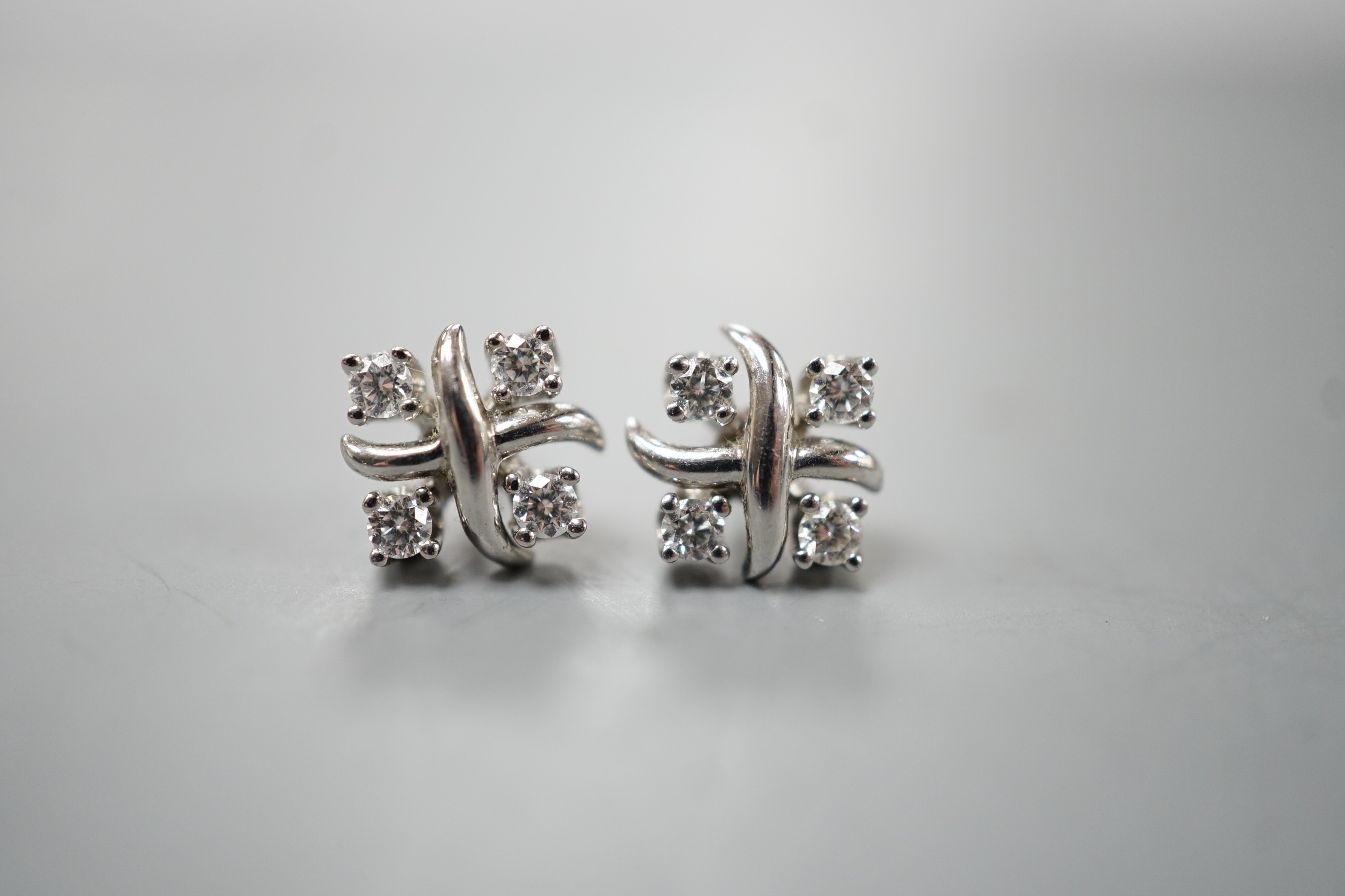 A modern pair of Tiffany & Co platinum and four stone diamond set square cluster ear studs, 7mm, gross weight 3.9 grams, (associated butterflies).